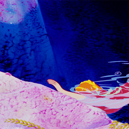 gif of a red-haired mermaid from peter pan flipping her hair