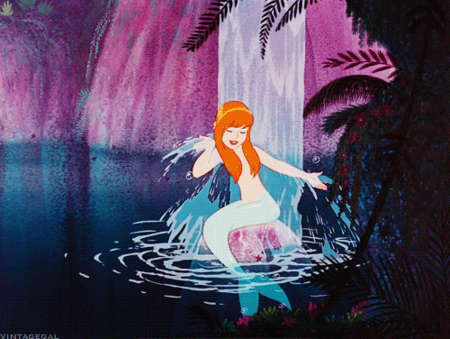 gif of a red-haired mermaid from peter pan under a waterfall
